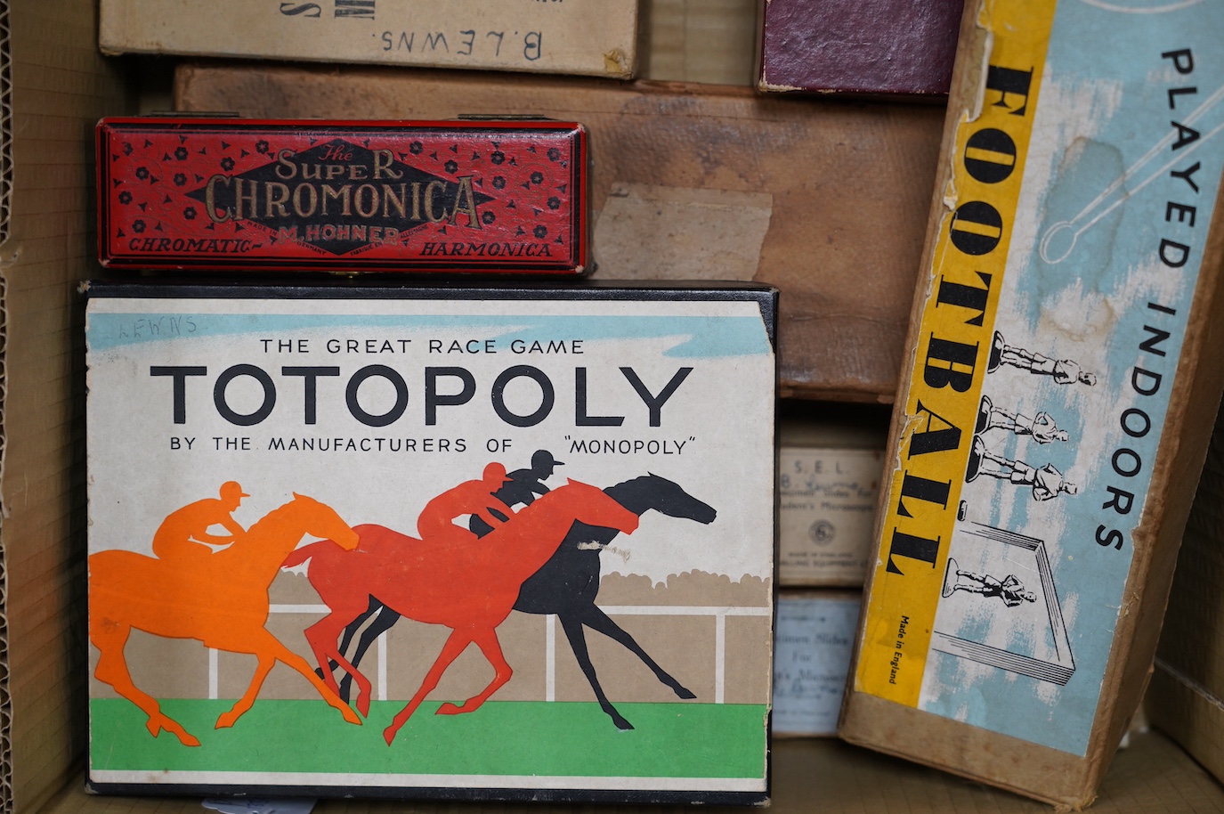 Eight 20th century to mid 20th century toys etc. including; an early boxed Subbuteo table soccer goal post set, a student microscope with slides, a boxed Balyna table football set, a Totopoly board game, a leatherworking